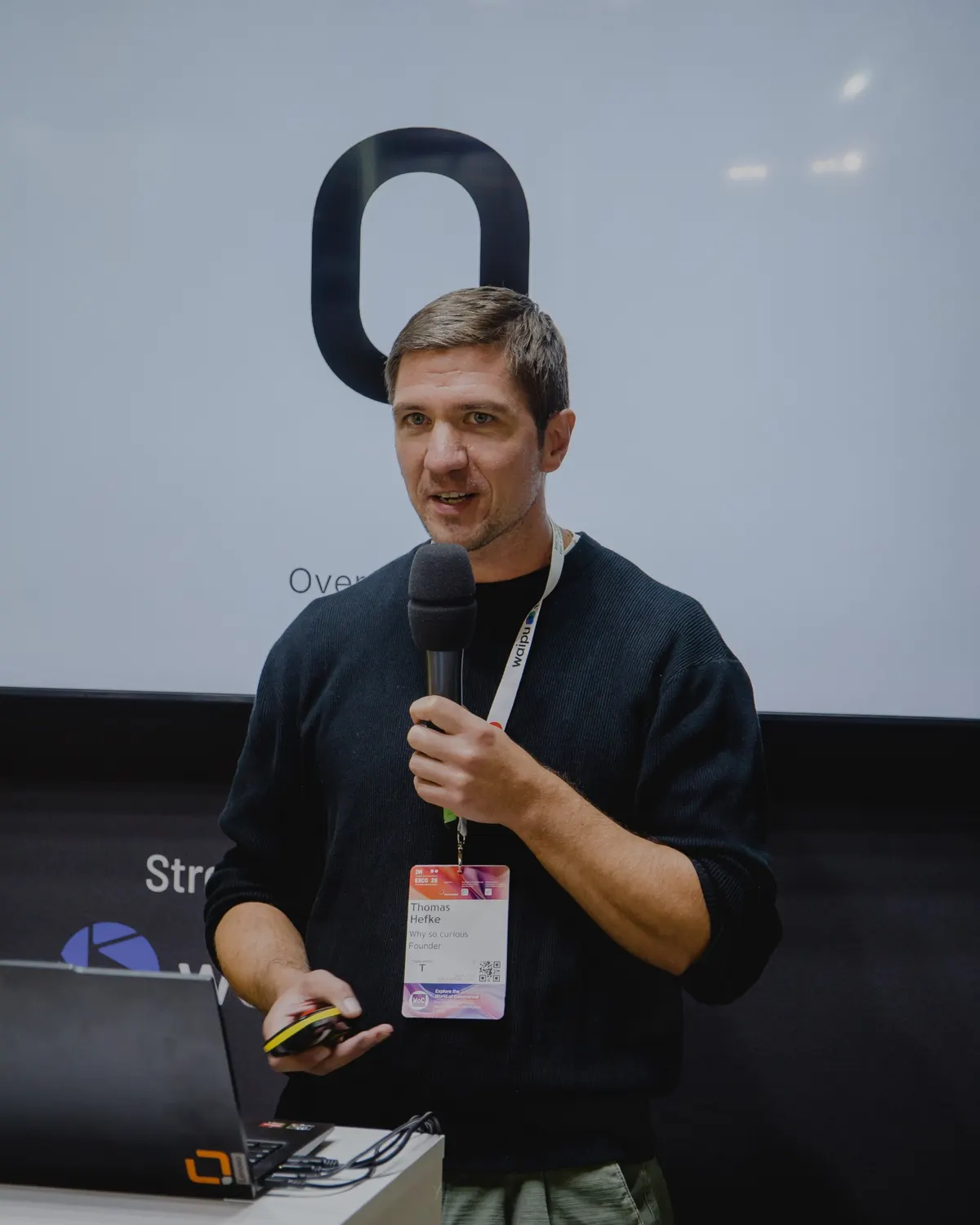 Thomas Hefke auf der Digital Bash Stage der DMEXCO 2026, auf dem Screen der Buchstabe O für Overwhelm aus dem BLOCK-Framework